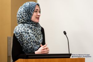 Shannon Al-Wakeel of the Muslim Justice League speaks in front of a microphone.
