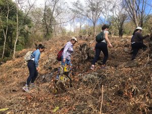 Women walk over unpaved roads.