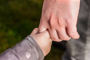 Child and parent holding hands